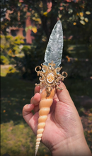 Charger l'image dans la galerie, Hand holding the unique Crystal Ritual Dagger, displaying the full length and ergonomic design of the fossil and glass handle