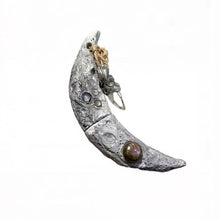 Cargar imagen en el visor de la galería, Handcrafted Crescent Moon Witchblade pendant featuring realistic lunar crater texture, inlaid with Labradorite and Moonstone, attached with a natural crystal charm. Perfect for Wiccan rituals and spiritual practices.